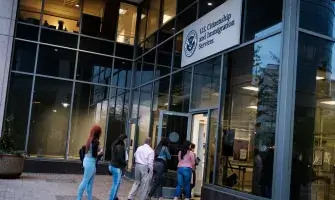 People enter Citizenship and Immigration Services in Fairfax, Va., on April 22, 2019.