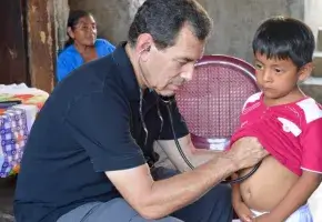 Paul Wise treating a child in a rural village in Guatemala